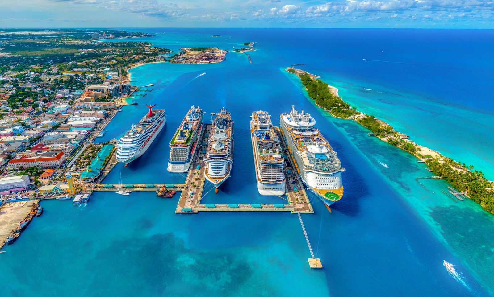 Cruise ships docked in a turquoise tropical harbor