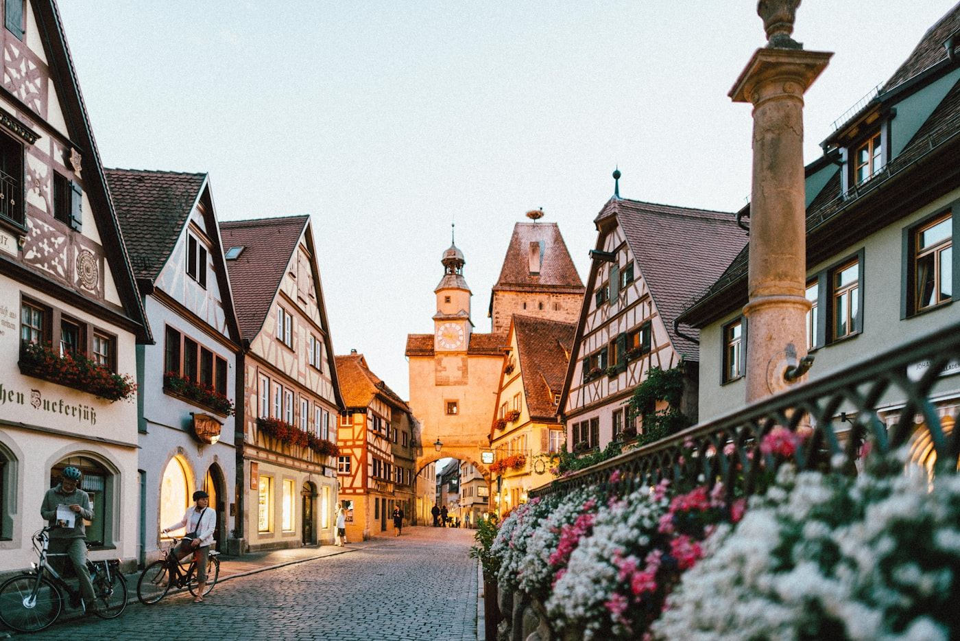 Cobblestone street and clock tower in a historic European town at golden hour
